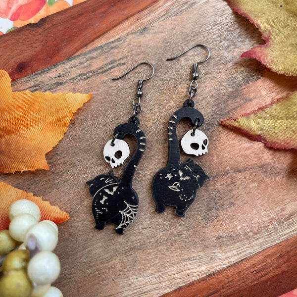 Wood Engraved Black Kitties Holding Ivory Skull Earrings